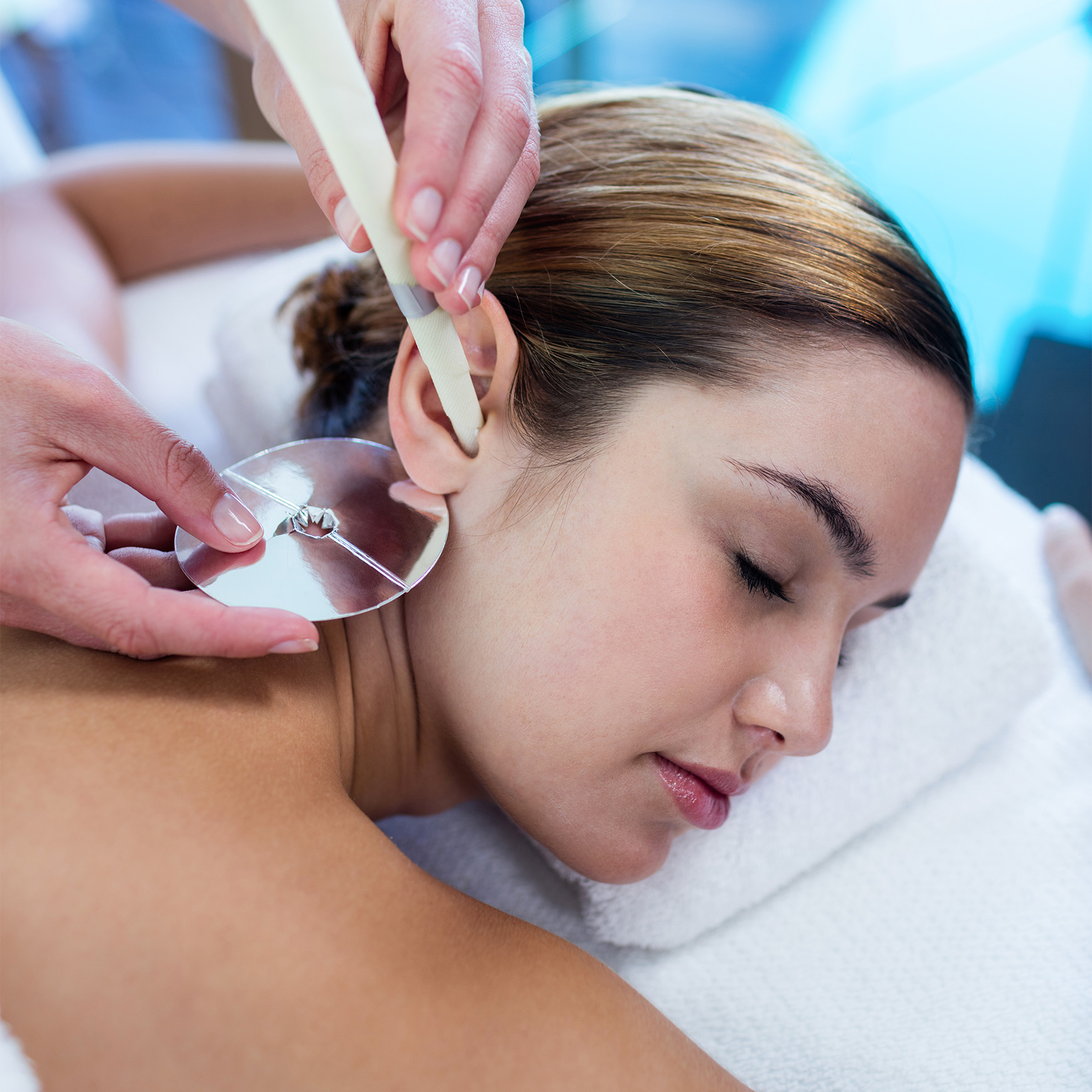 woman-receiving-ear-candle-treatment